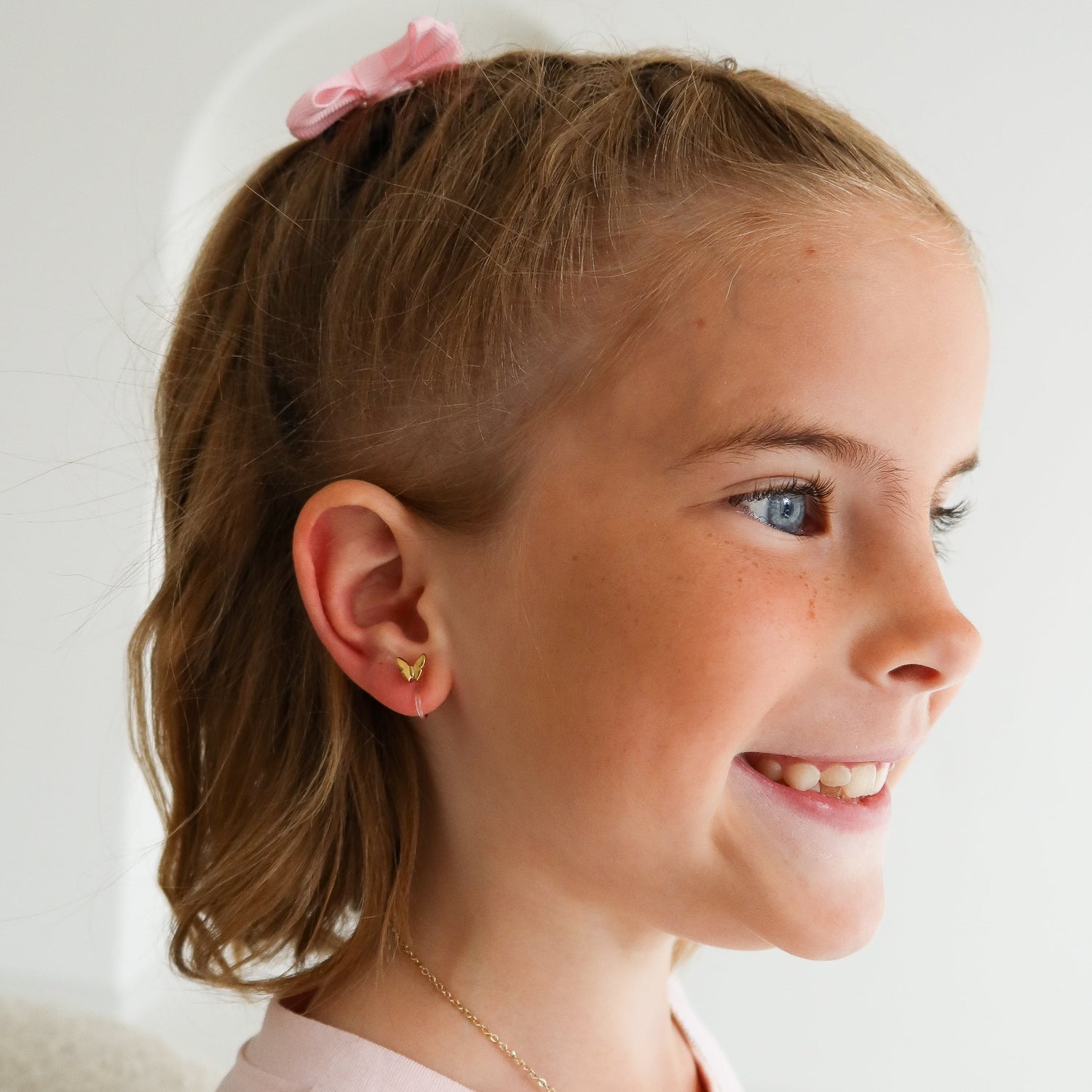 Butterfly Kinder Ohrclips in Gold am Ohr getragen